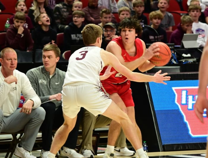 Treynor's Ethan Konz scands the court while being defended by Western Christian's Caleb Douma during a Class 2A state tournament semifinal at Wells Fargo Arena in Des Moines on Thursday. (Photo by Ryan Timmerman)